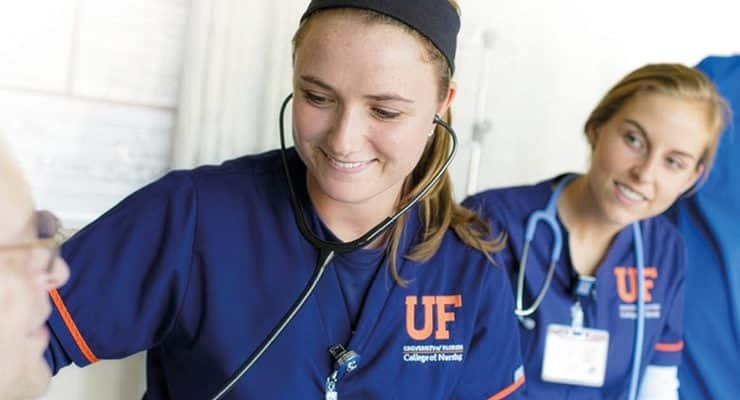 nursing students from the University of Florida College of Nursing interacting with a patient