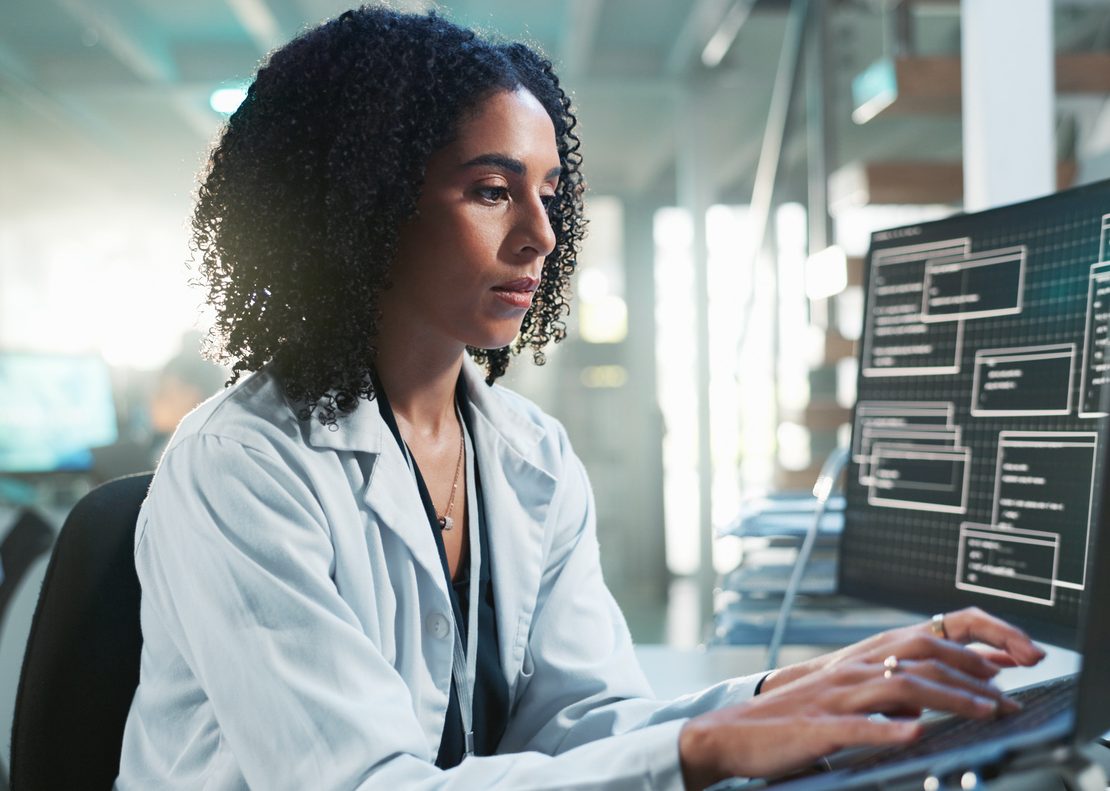 Healthcare professional reviewing AI-generated clinical insights alongside patient data in a modern hospital environment.