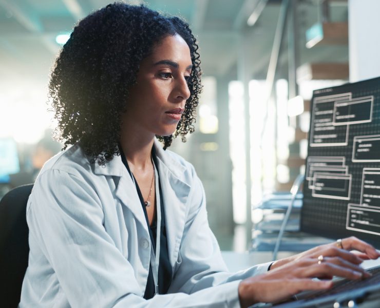 Healthcare professional reviewing AI-generated clinical insights alongside patient data in a modern hospital environment.