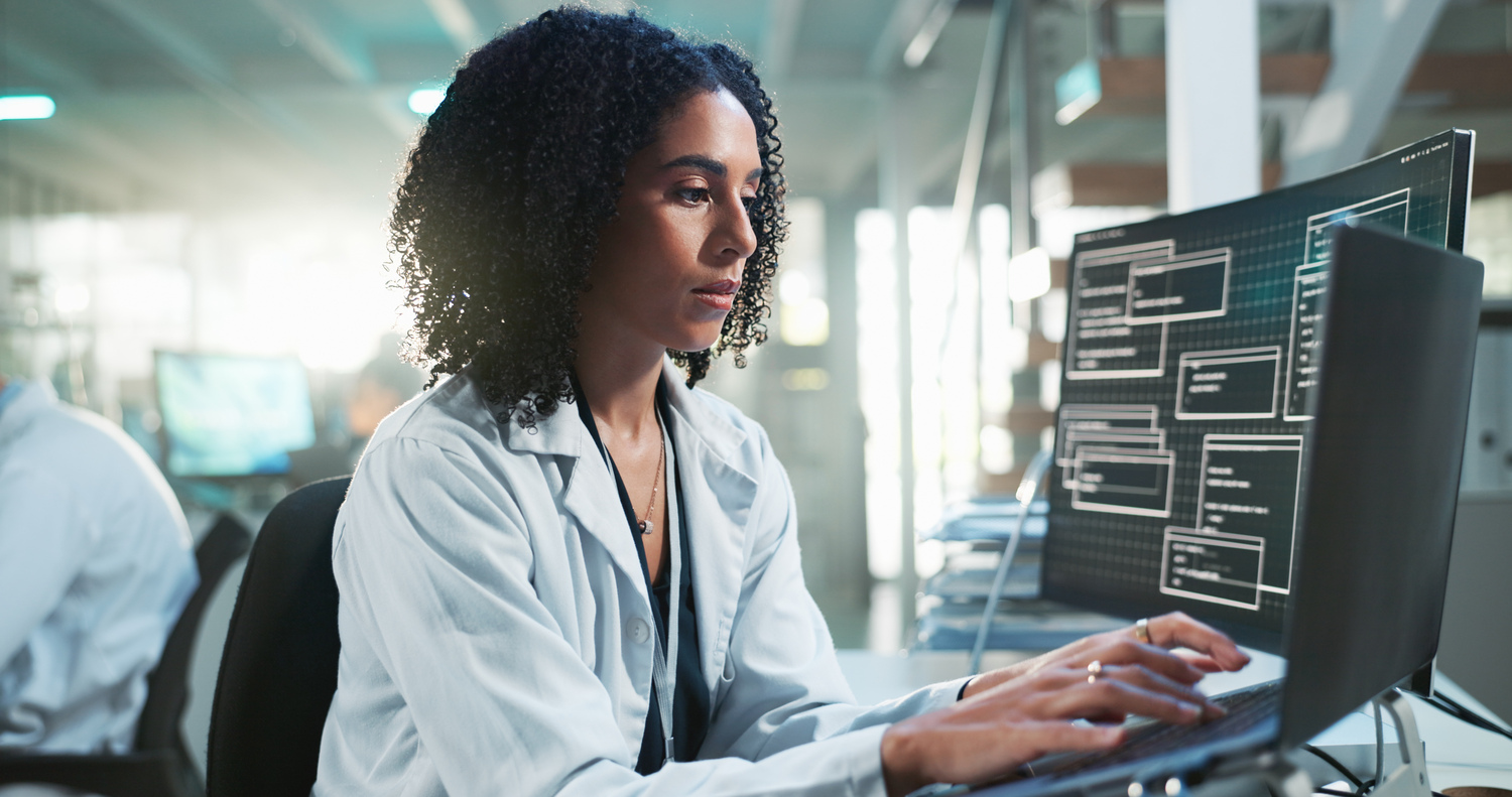 Healthcare professional reviewing AI-generated clinical insights alongside patient data in a modern hospital environment.