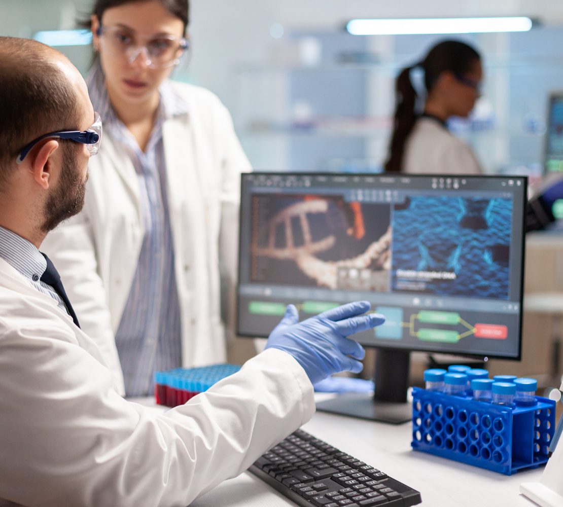 Researchers working in a biotechnology laboratory as pharmaceutical companies increase acquisitions to strengthen future drug pipelines.