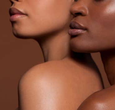 a close-up portrait of two individuals highlighting diverse skin tones and textures
