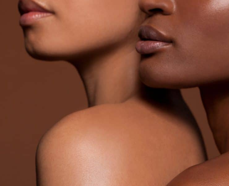 a close-up portrait of two individuals highlighting diverse skin tones and textures