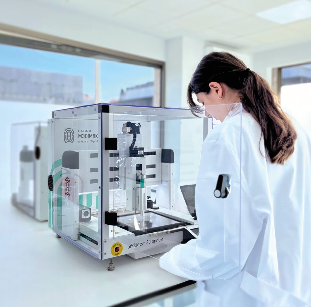 a laboratory setting featuring a pharmaceutical 3D printer