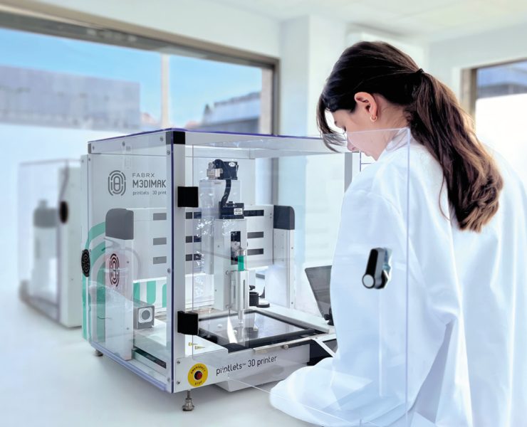 a laboratory setting featuring a pharmaceutical 3D printer