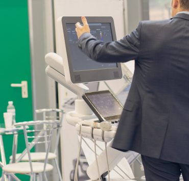 Medical device sales representative using AI-powered sales intelligence software to analyze hospital accounts and improve commercial performance.