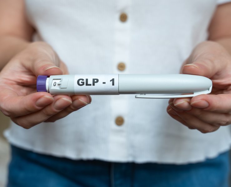 A woman holding a GLP-1 weight loss drug as manufacturers developing next-generation obesity and weight loss medicines.