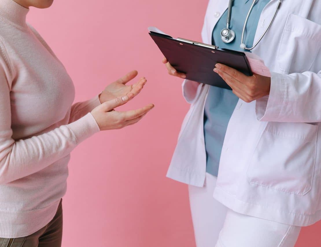 Healthcare professional discussing surrogacy care and treatment options with a patient.