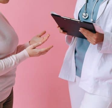 Healthcare professional discussing surrogacy care and treatment options with a patient.