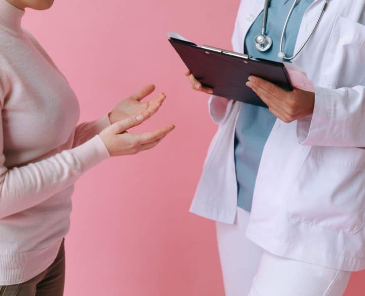 Healthcare professional discussing surrogacy care and treatment options with a patient.