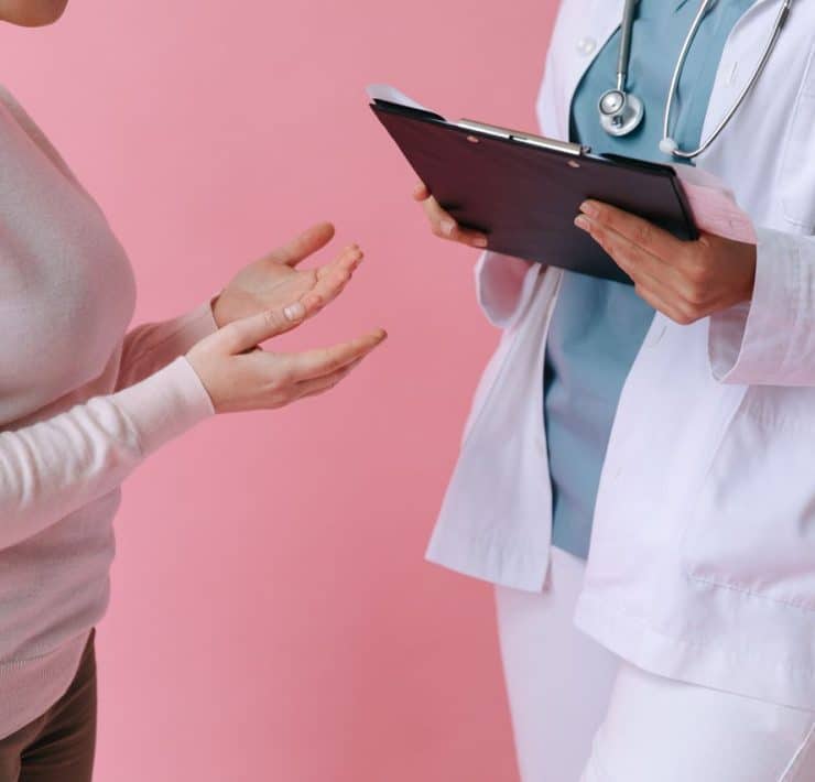 Healthcare professional discussing surrogacy care and treatment options with a patient.