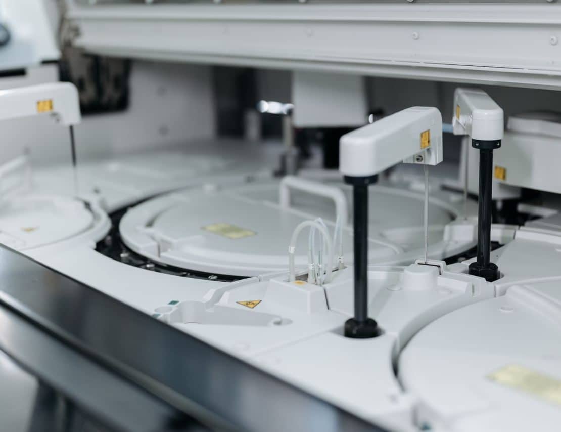 **Alt text:** Automated laboratory equipment performing high-throughput sample processing and analysis.