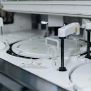 **Alt text:** Automated laboratory equipment performing high-throughput sample processing and analysis.