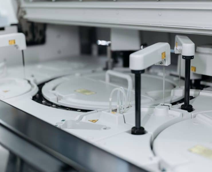 **Alt text:** Automated laboratory equipment performing high-throughput sample processing and analysis.