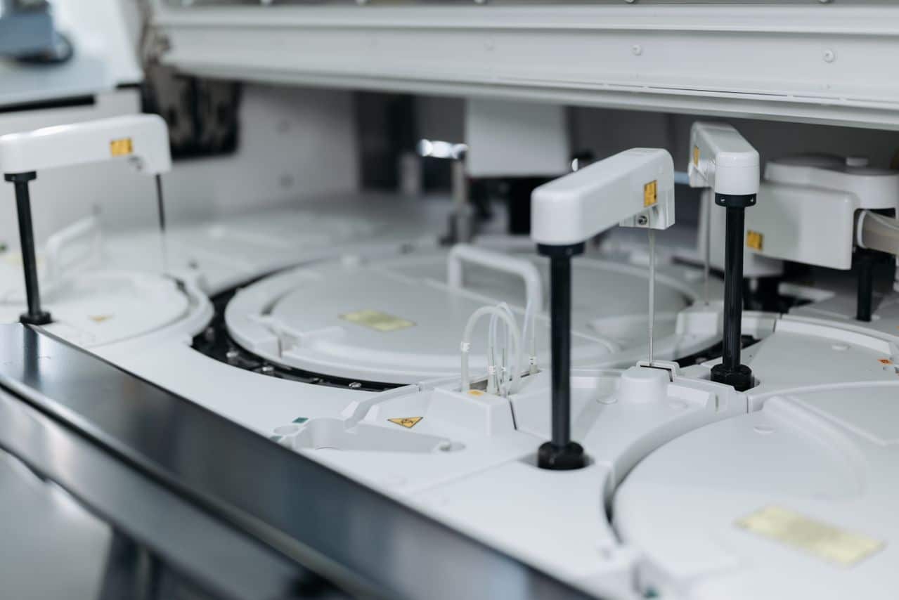**Alt text:** Automated laboratory equipment performing high-throughput sample processing and analysis.