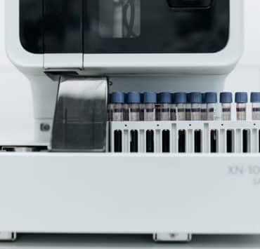 Automated laboratory equipment processing blood samples for diagnostic testing
