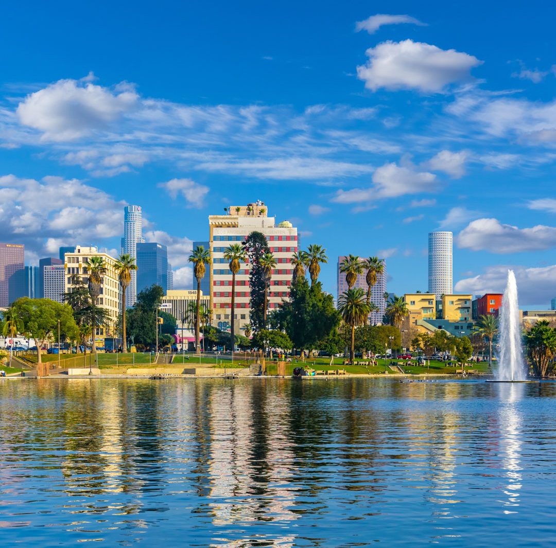 the view across MacArthur Park Lake toward the Downtown Los Angeles skyline in California