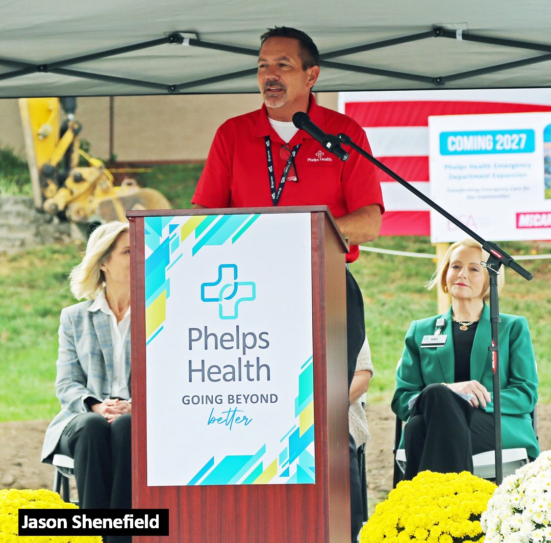 a podium and banner for Phelps Health with the slogan "GOING BEYOND better"