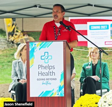 a podium and banner for Phelps Health with the slogan "GOING BEYOND better"