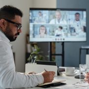 Clinician using an AI decision support tool on a tablet in a hospital