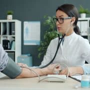 Physical therapist guiding a patient through knee rehabilitation exercises in an outpatient clinic