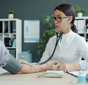 Physical therapist guiding a patient through knee rehabilitation exercises in an outpatient clinic
